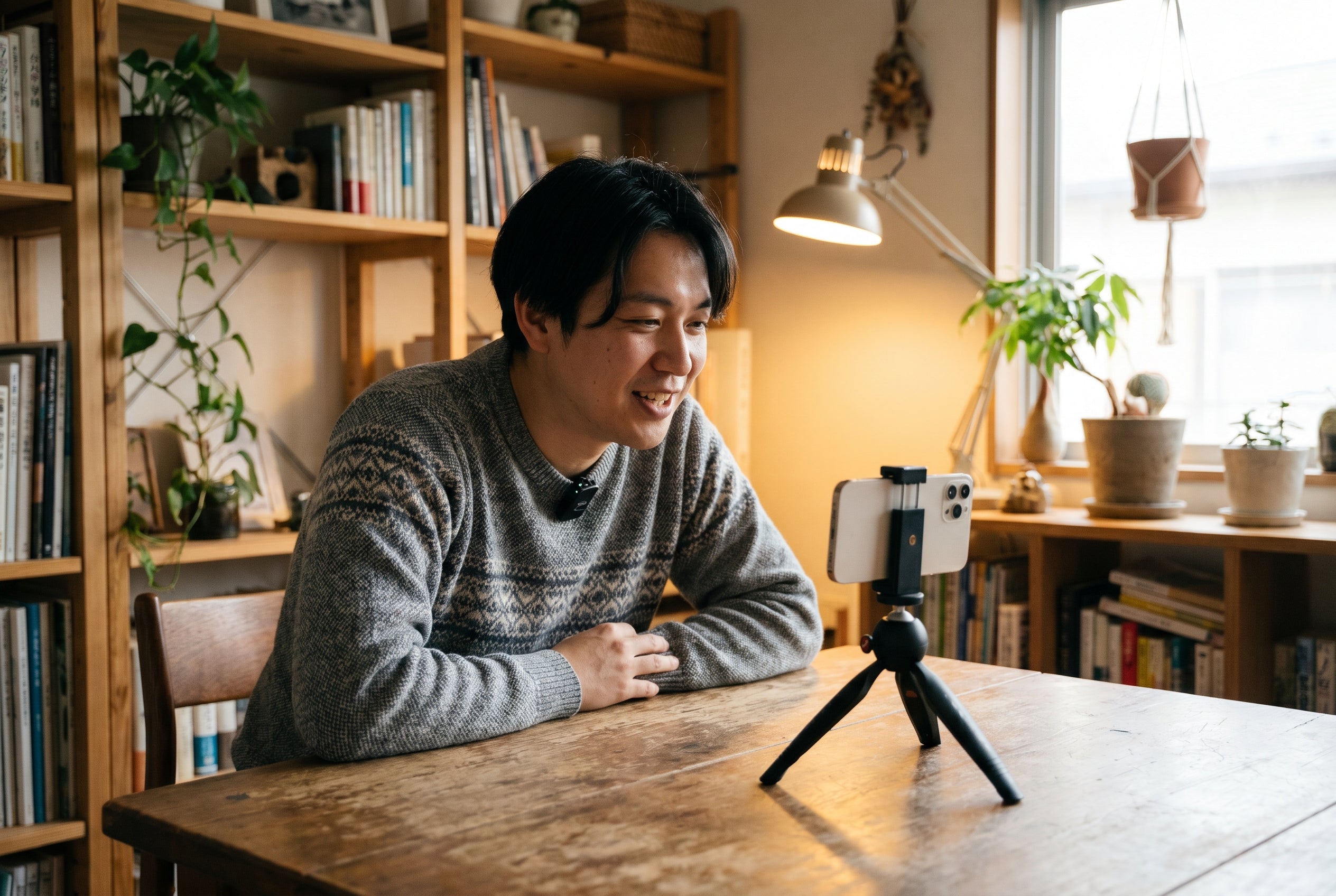 Content creator recording a podcast on their iPhone with a wireless lavalier microphone